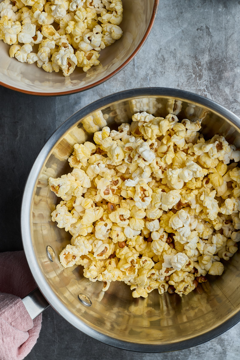 Transfer the popcorn into a wide bowl.