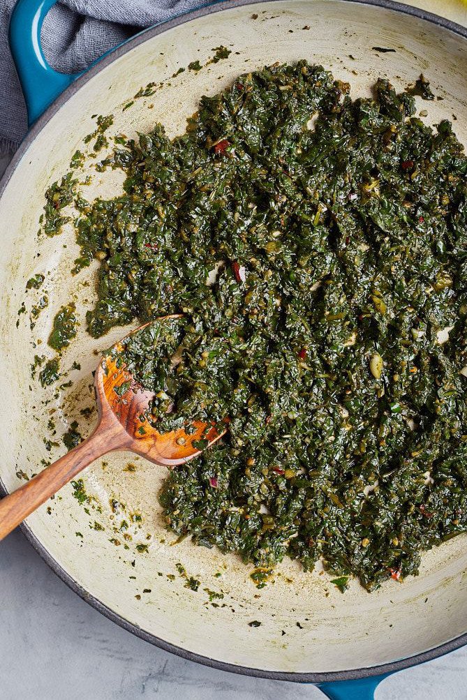 Cook homemade pesto with chili in pan.