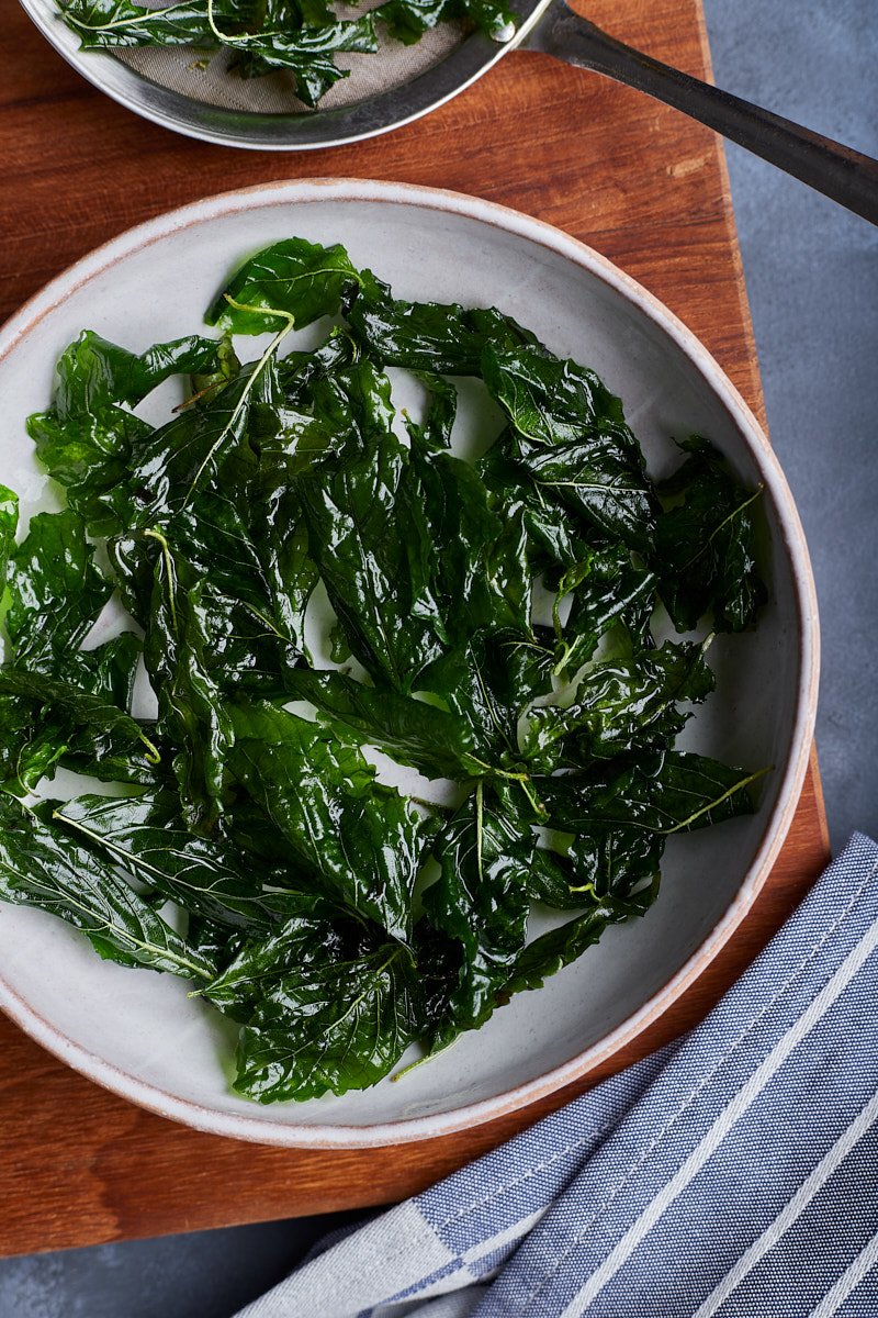 Crispy basil makes for topping on the dishes.