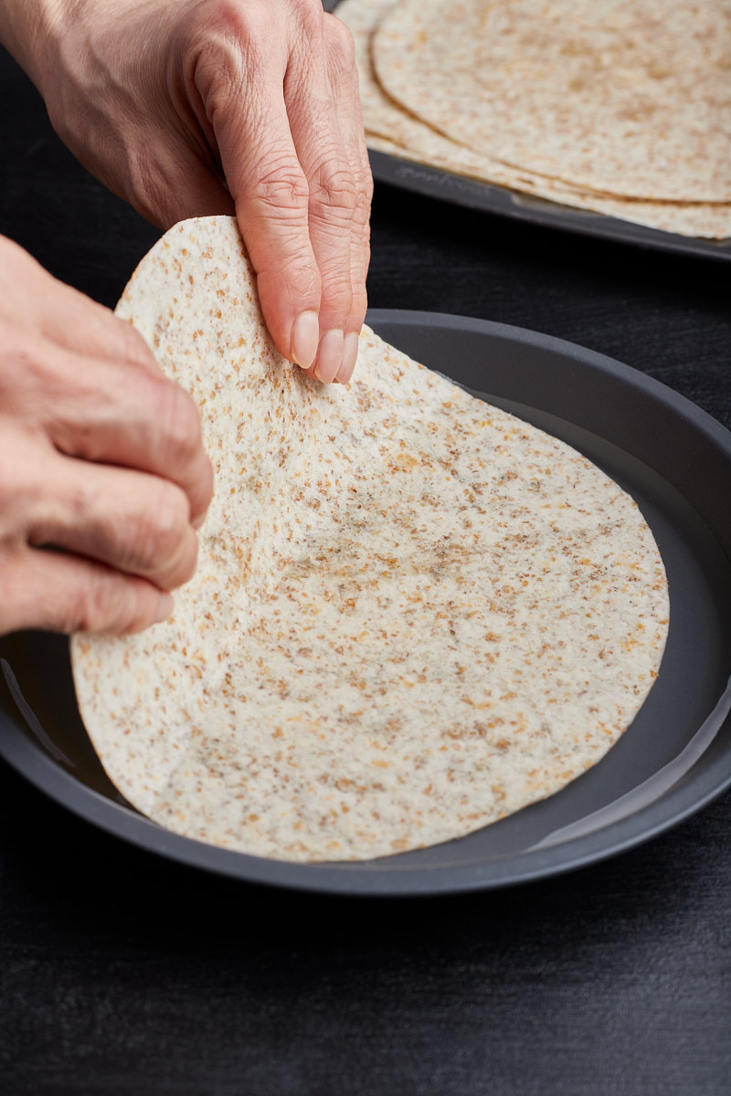 Dip tortillas briefly in water.