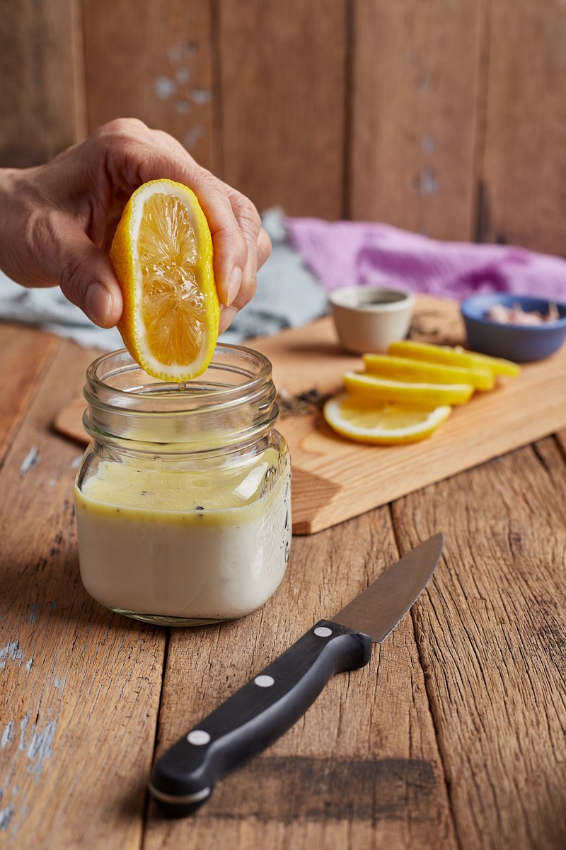 Squeeze lemon juice in dressing jar.