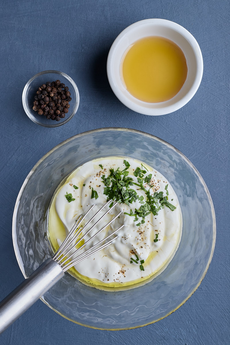 Making dressing with Greek yogurt and olive oil.