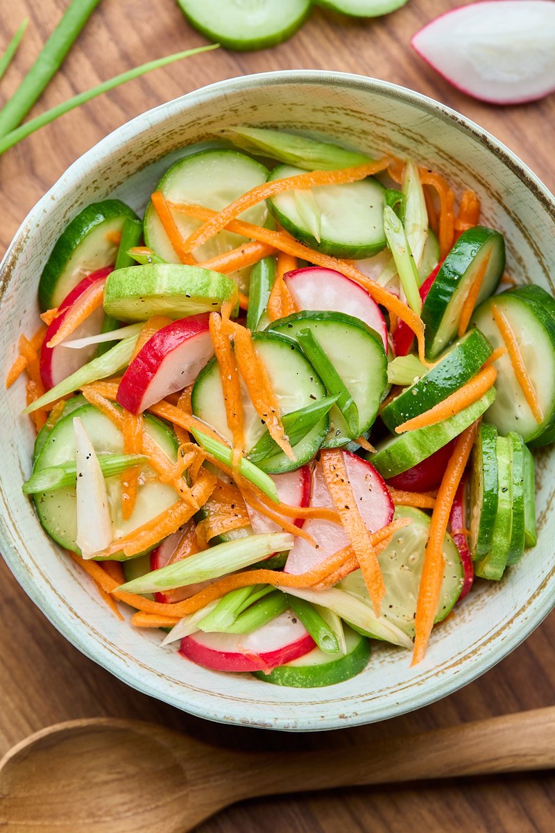 Sweet and tart cucumber salad serve as a side dish.