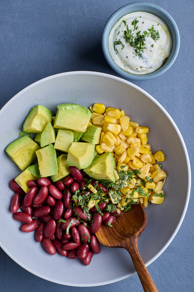 Add red beans and corn kernel with Greek dressing.