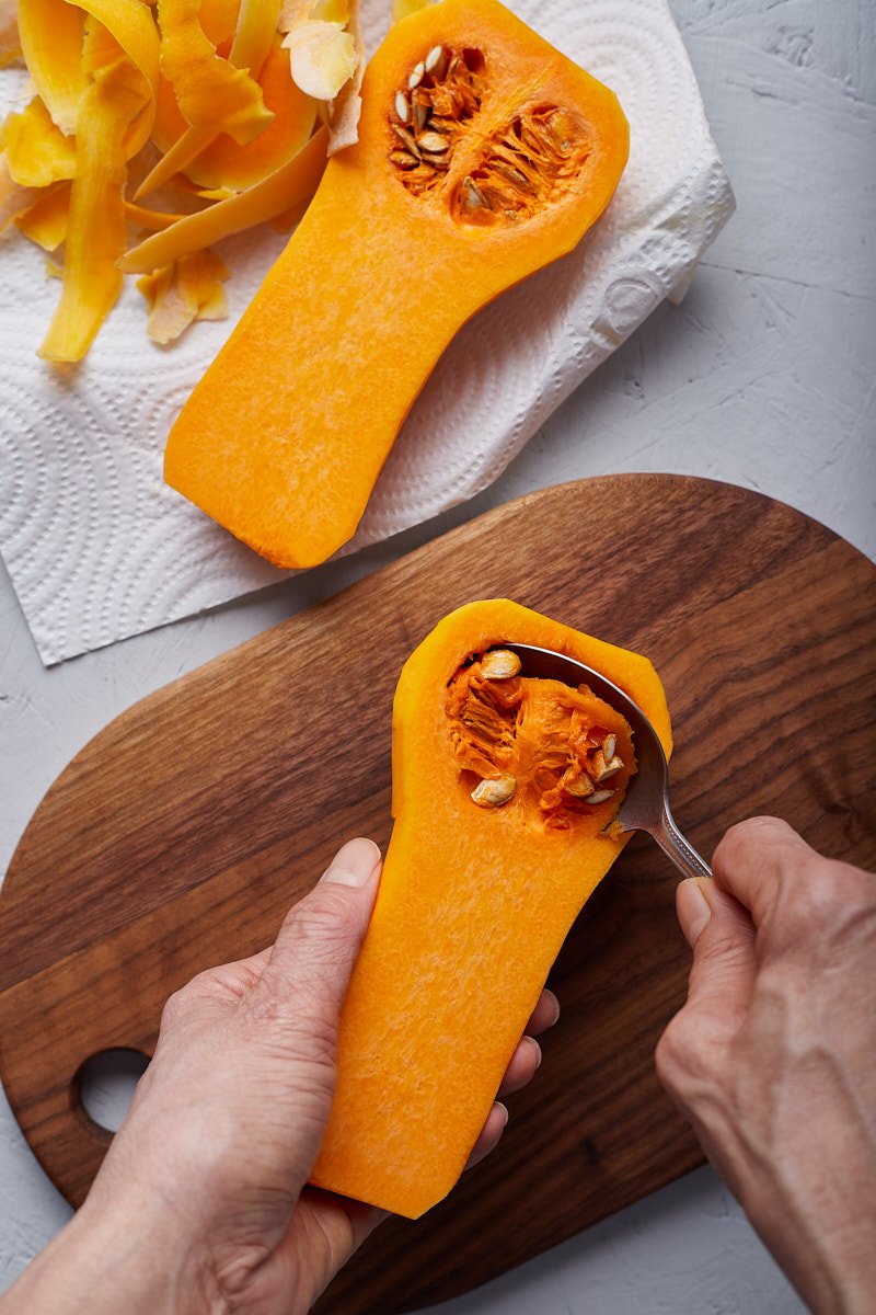 Step 3, Cut the squash in half lengthwise and remove the seeds.