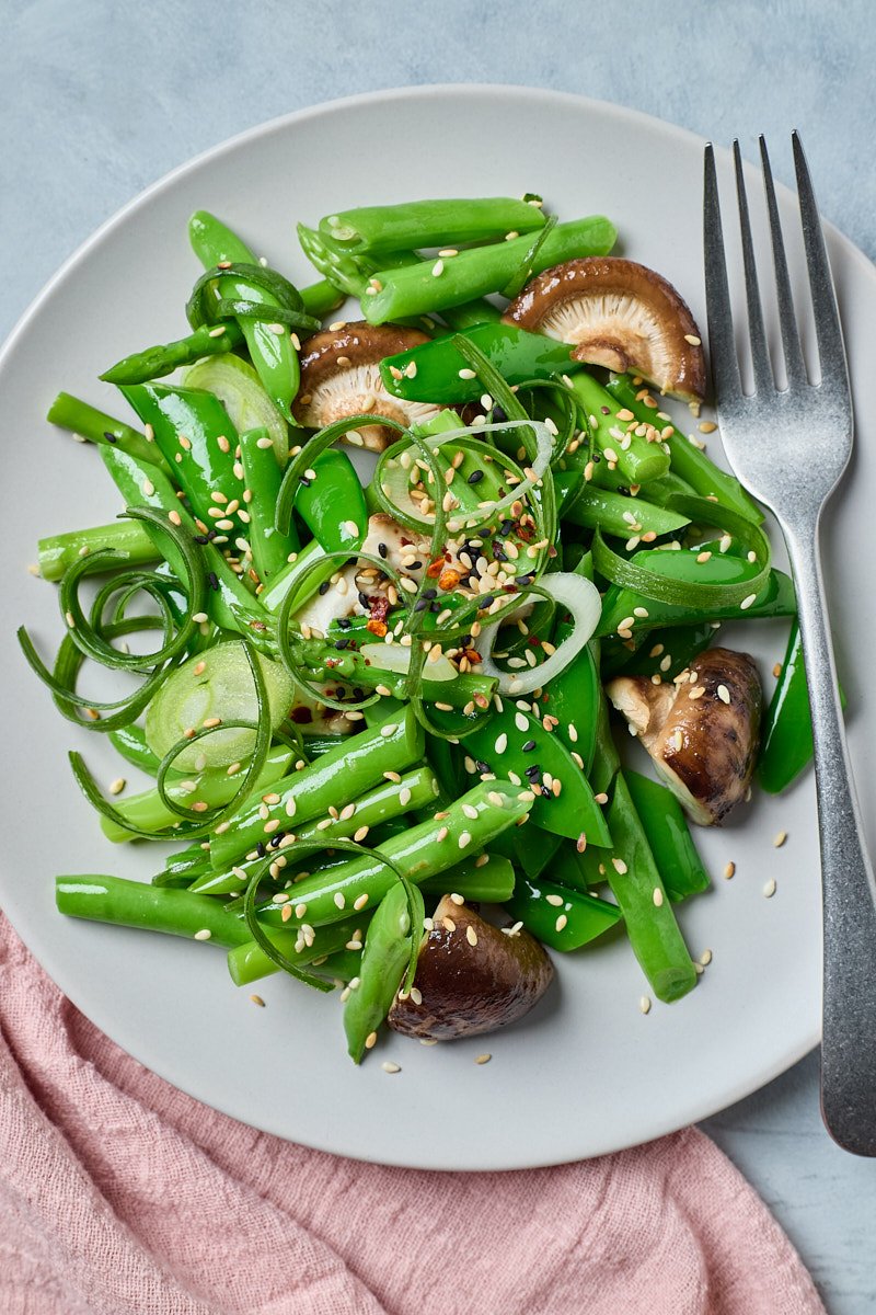 Green beans tossed with light soy sauce brighten the dressing.