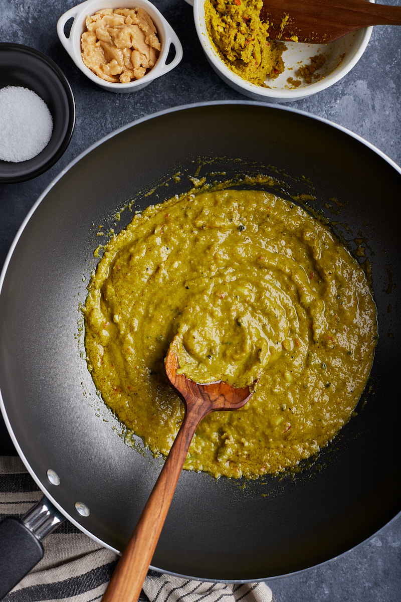 Cook green curry paste with coconut milk until fragrance.