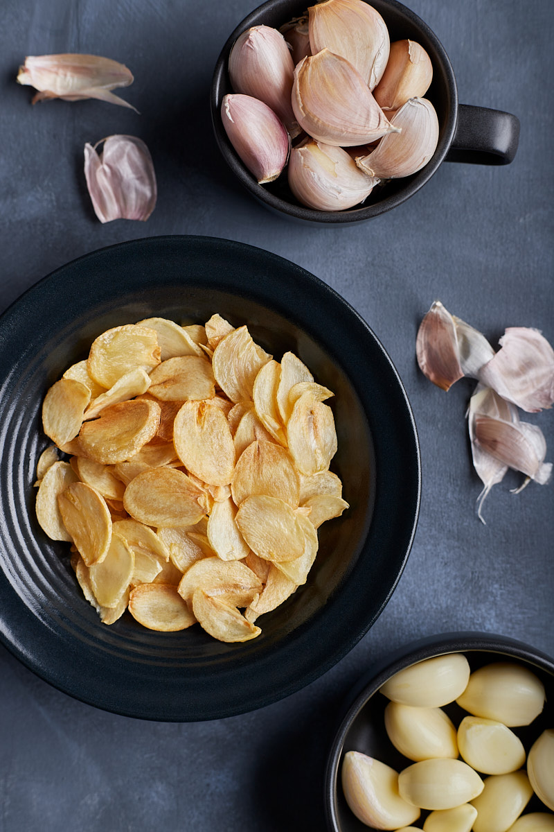 Garlic chips are the topping to spiced up noodle dish.