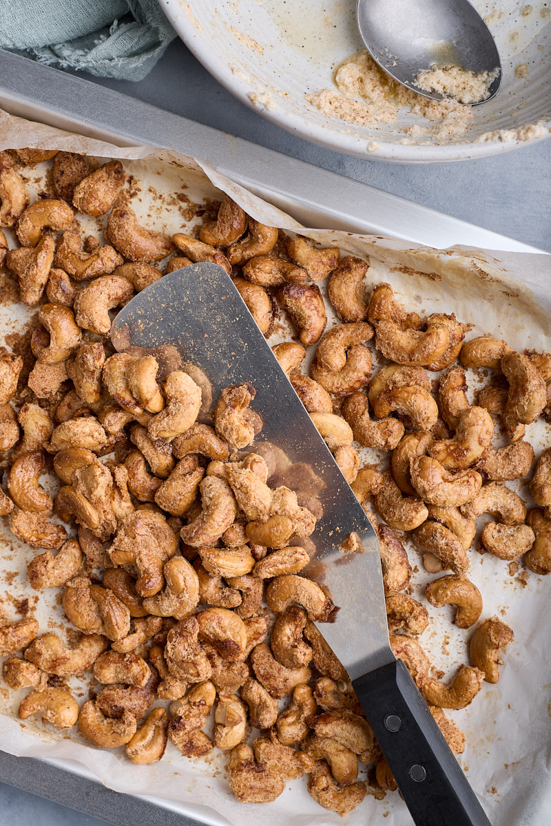 Use a metal spatula stir to separate roasted nuts.