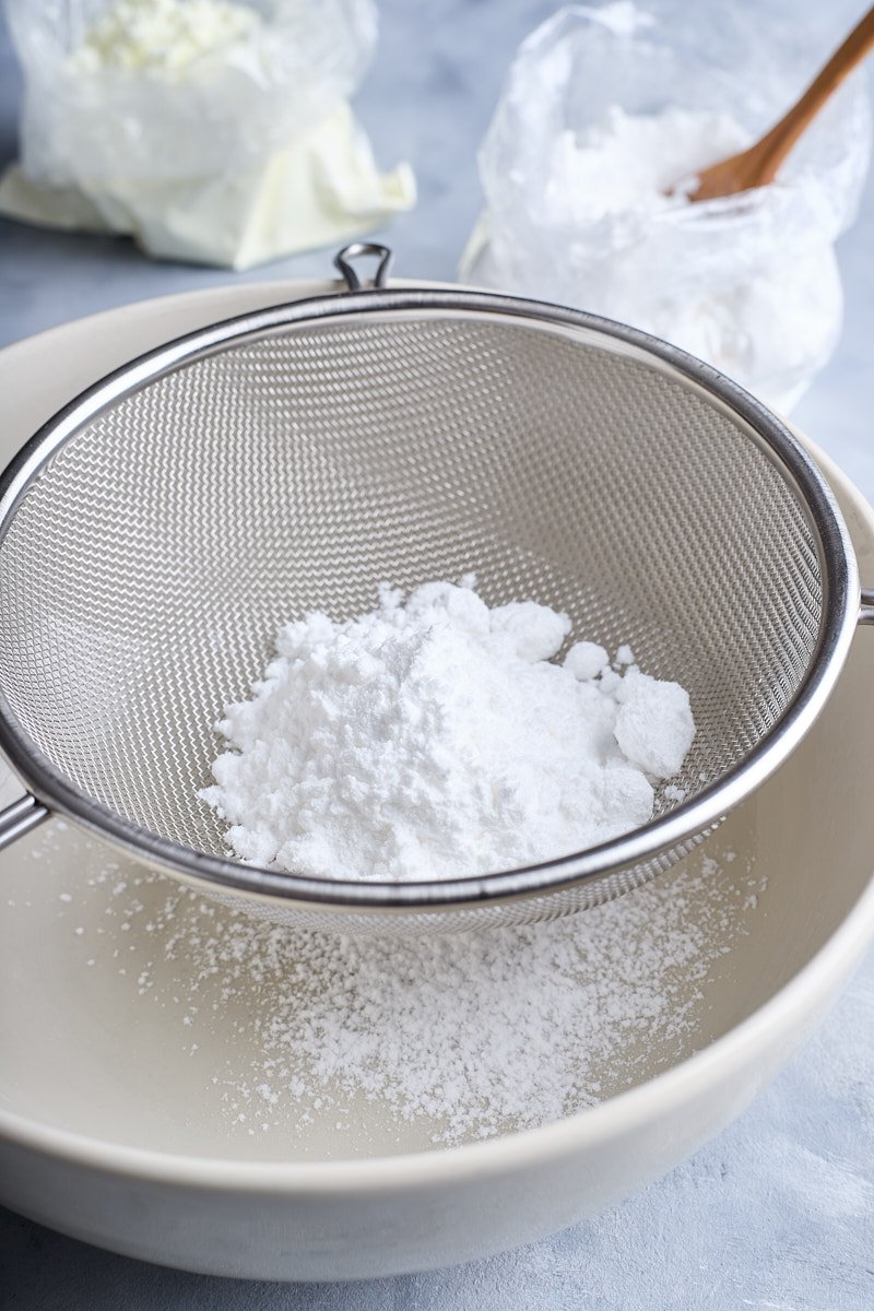 Sift confectioners’ sugar in a bowl.